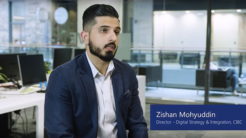 Man named Zishan Mohyuddin, Director of Digital Strategy and Integration at CIBC, sits in office and talks to camera.
