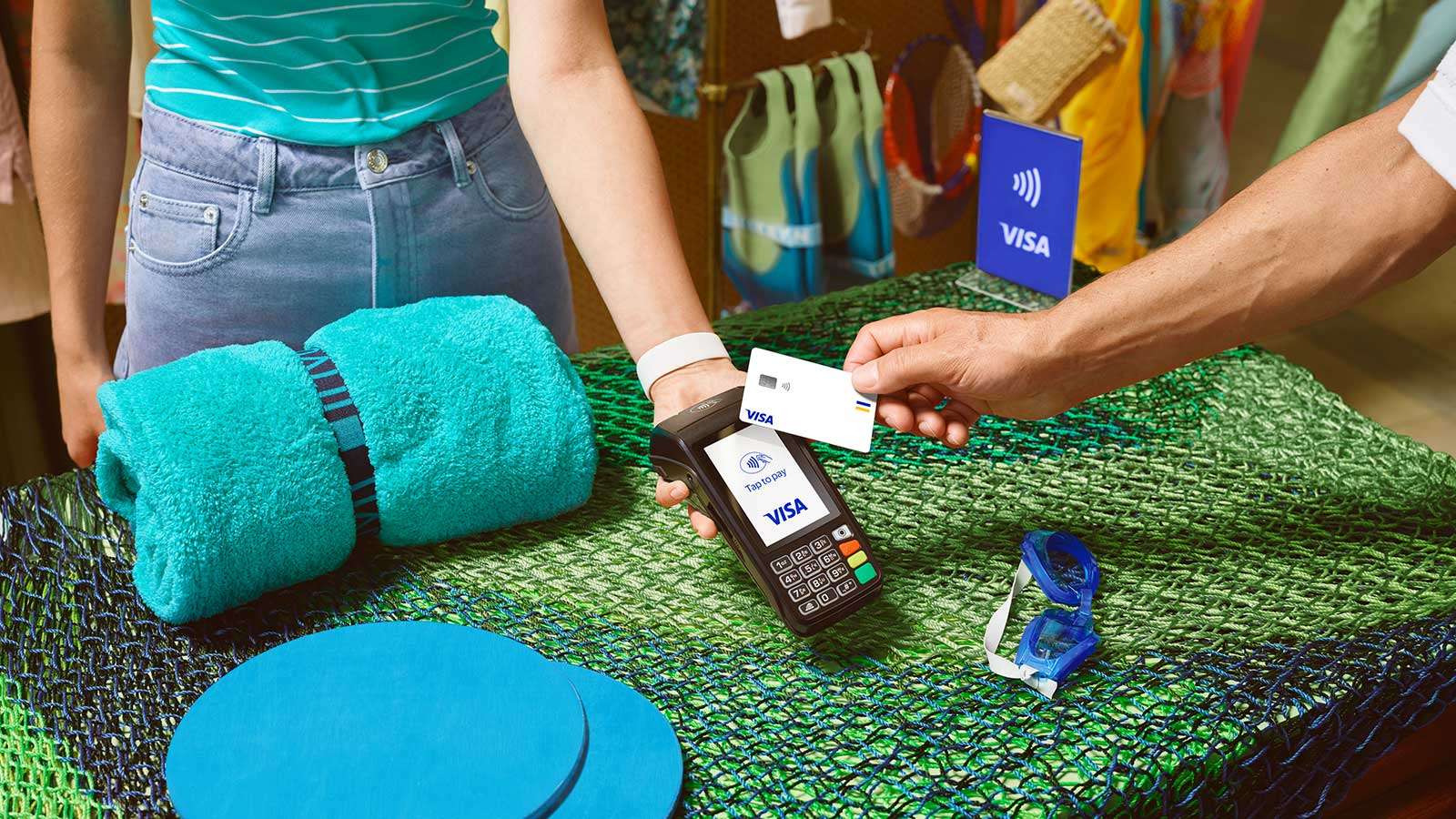 person paying with their visa card on holiday