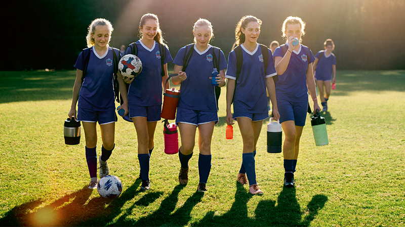 Female footballers walking off pitch